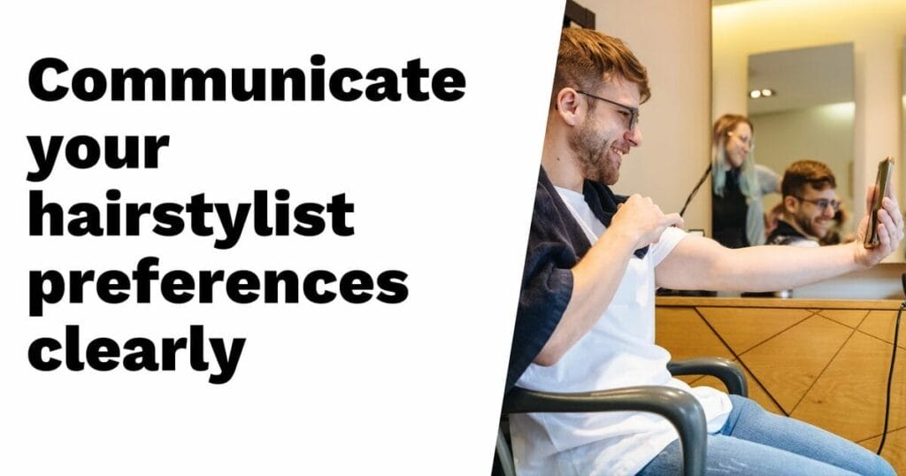 Man sitting in a salon chair showing a photo on his phone to his hairstylist, with text: "Communicate your hairstylist preferences clearly.